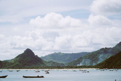 Scenic view of sea and mountains against sky