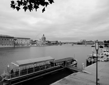 Bridge over river against buildings in city