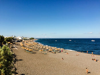 Scenic view of beach against clear blue sky