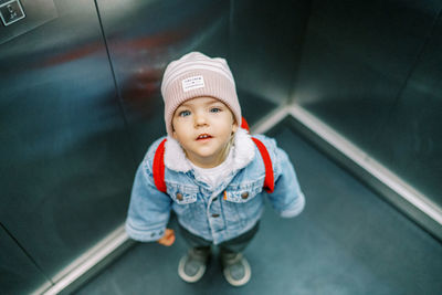 High angle view of cute boy standing on road