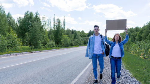 Rear view of woman walking on road