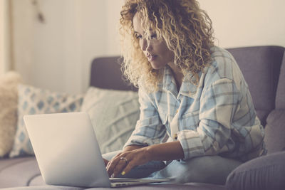 Young woman using laptop at home