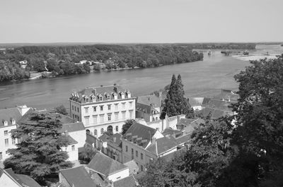 High angle view of buildings by river against sky