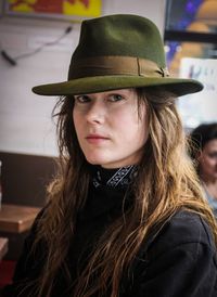 Close-up portrait of young woman in hat