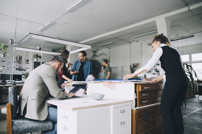 Multi-ethnic male and female entrepreneurs working in creative office