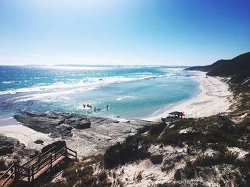 Scenic view of beach against clear blue sky