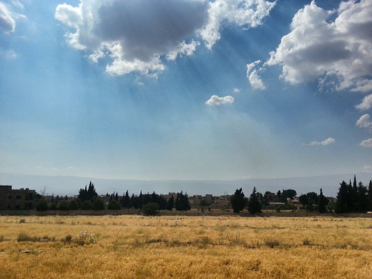 sky, landscape, tranquil scene, tranquility, field, scenics, nature, beauty in nature, cloud - sky, rural scene, grass, horizon over land, cloud, growth, plant, non-urban scene, agriculture, blue, remote, idyllic