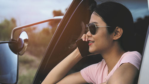 Midsection of woman sitting in car