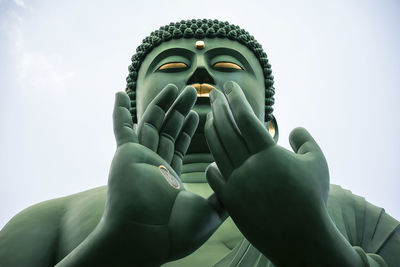 Low angle view of buddha statue against clear sky