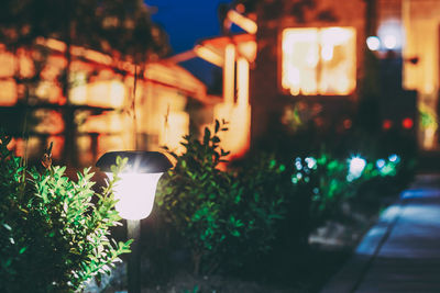 Close-up of illuminated lighting equipment on street at night