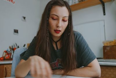 Young beautiful woman with the smartphone at home