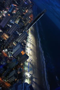 High angle view of illuminated cityscape against sky at night