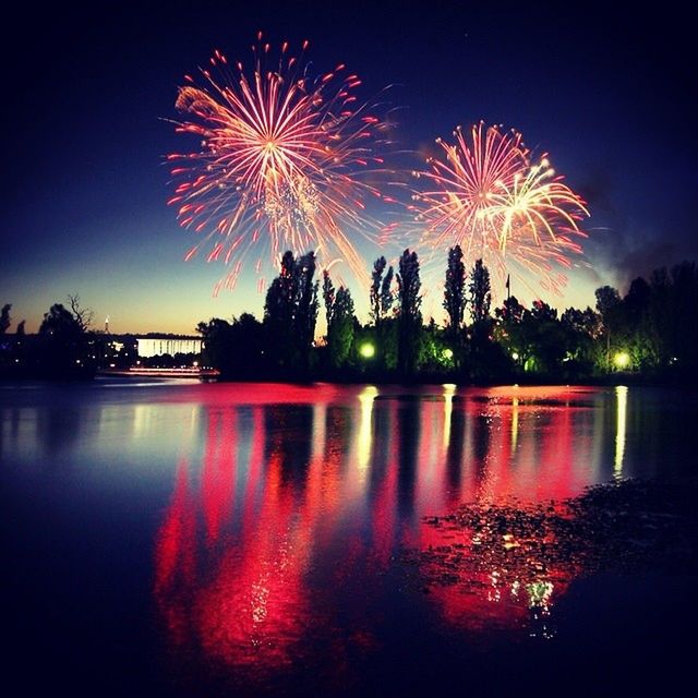 illuminated, night, firework display, water, reflection, long exposure, celebration, exploding, firework - man made object, glowing, waterfront, firework, arts culture and entertainment, sky, event, motion, multi colored, sparks, entertainment, lake