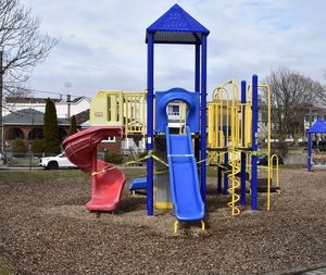 Playground in park against blue sky