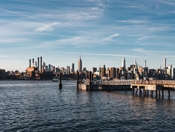 Sunset over east river midtown manhattan skyline and north 5th street pier at brooklyn