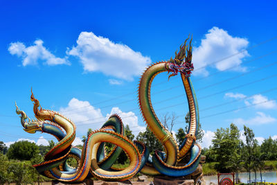 Low angle view of sculpture against blue sky