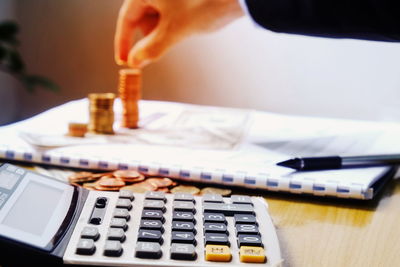 Business person using calculator at desk in office