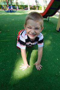 Cute boy sitting on grass