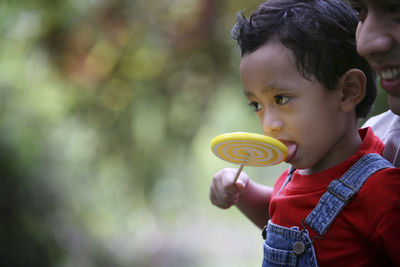 Portrait of cute boy looking away outdoors