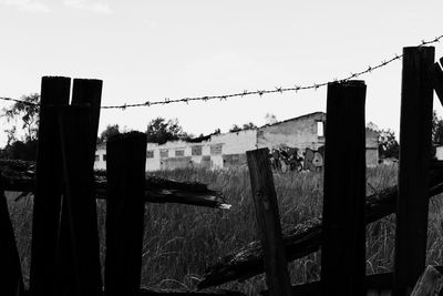 Clothes drying on wooden post against sky