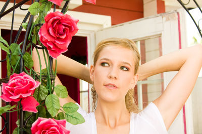 Close-up portrait of young woman holding bouquet