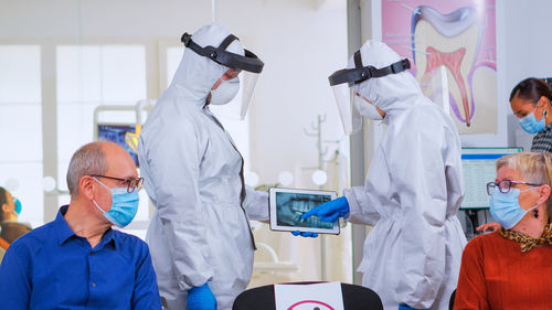 Rear view of doctors working at clinic