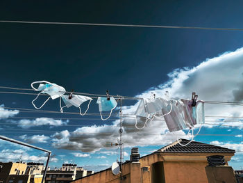 Masks on a low angle view of traditional building against sky