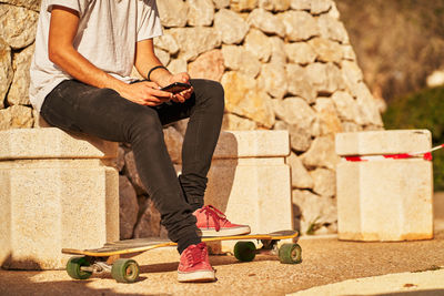 Low section of man skateboarding on skateboard