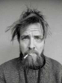 Portrait of bearded man smoking cigarette