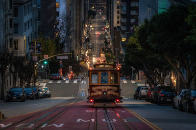 Illuminated city street at night