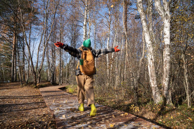 Full length of woman standing in forest