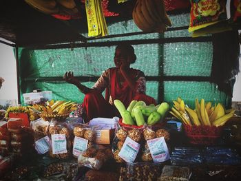 People sitting at market stall