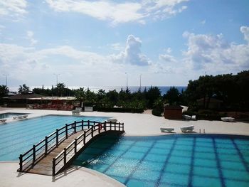 Overpass over swimming pool against sky