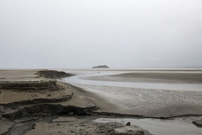 Scenic view of beach against clear sky