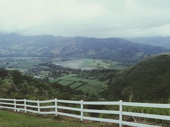 Scenic view of field and mountains against sky