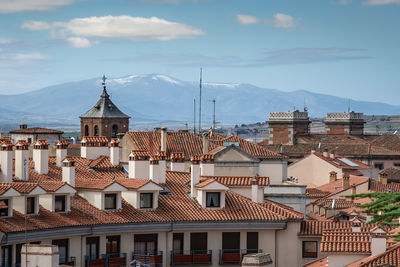 Buildings in town against sky