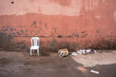 Abandoned garbage against wall