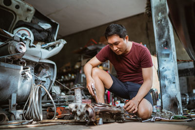 Side view of man working in workshop