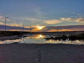 Scenic view of beach against sky during sunset