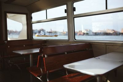 Empty chairs and table in ship restaurant