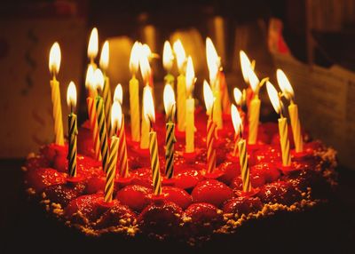 Close-up of burning candles on cake