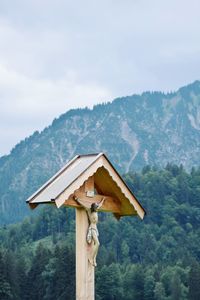 Traditional windmill against mountain range