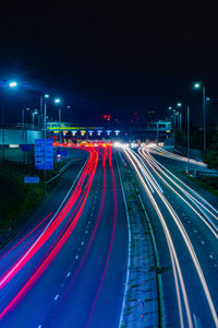 High angle view of light trails on road at night