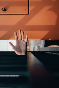 Cropped image of hand amidst metal