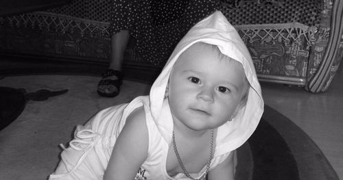 Close-up portrait of girl sitting on floor