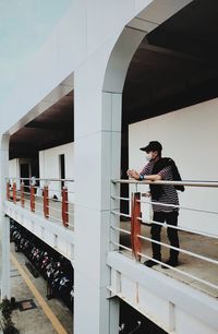 Man standing by railing