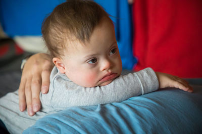 Midsection of mother with son sitting at home