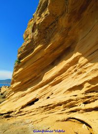 Scenic view of rocky beach against clear sky