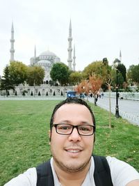 Portrait of smiling man against built structure