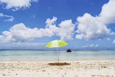 Scenic view of beach against blue sky